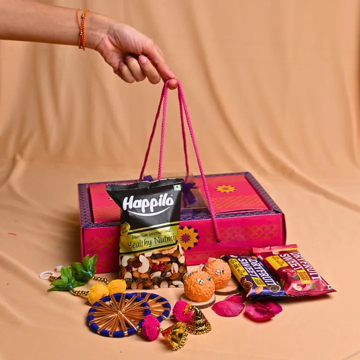 Celebration Treats Hamper, a Diwali gift hamper with Happilo Nutmix, Happilo Dryfruit Sweets and Door hangings