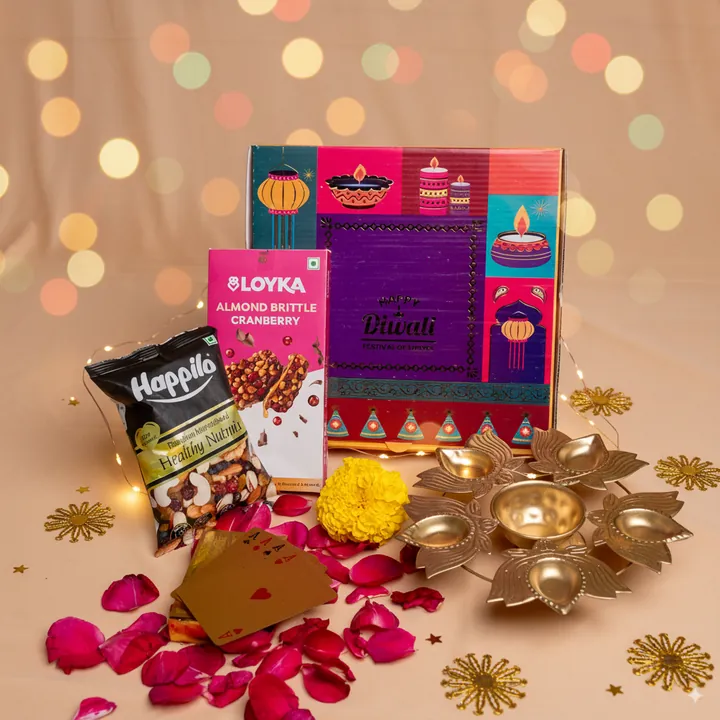 Festive Nutty Indulgence, a Diwali gift hamper with Happilo Nutmix, Loyka Almond Brittle and Golden playing cards