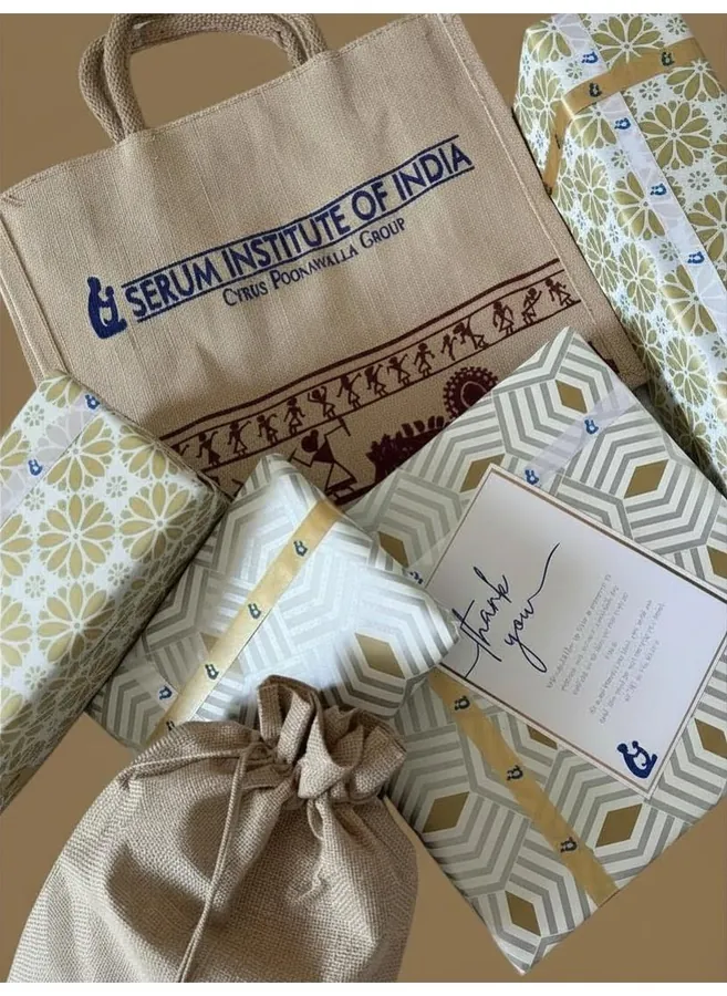 Serum Institute of India visitor hamper in a printed juco bag, with gift-wrapped boxes and a thank-you card